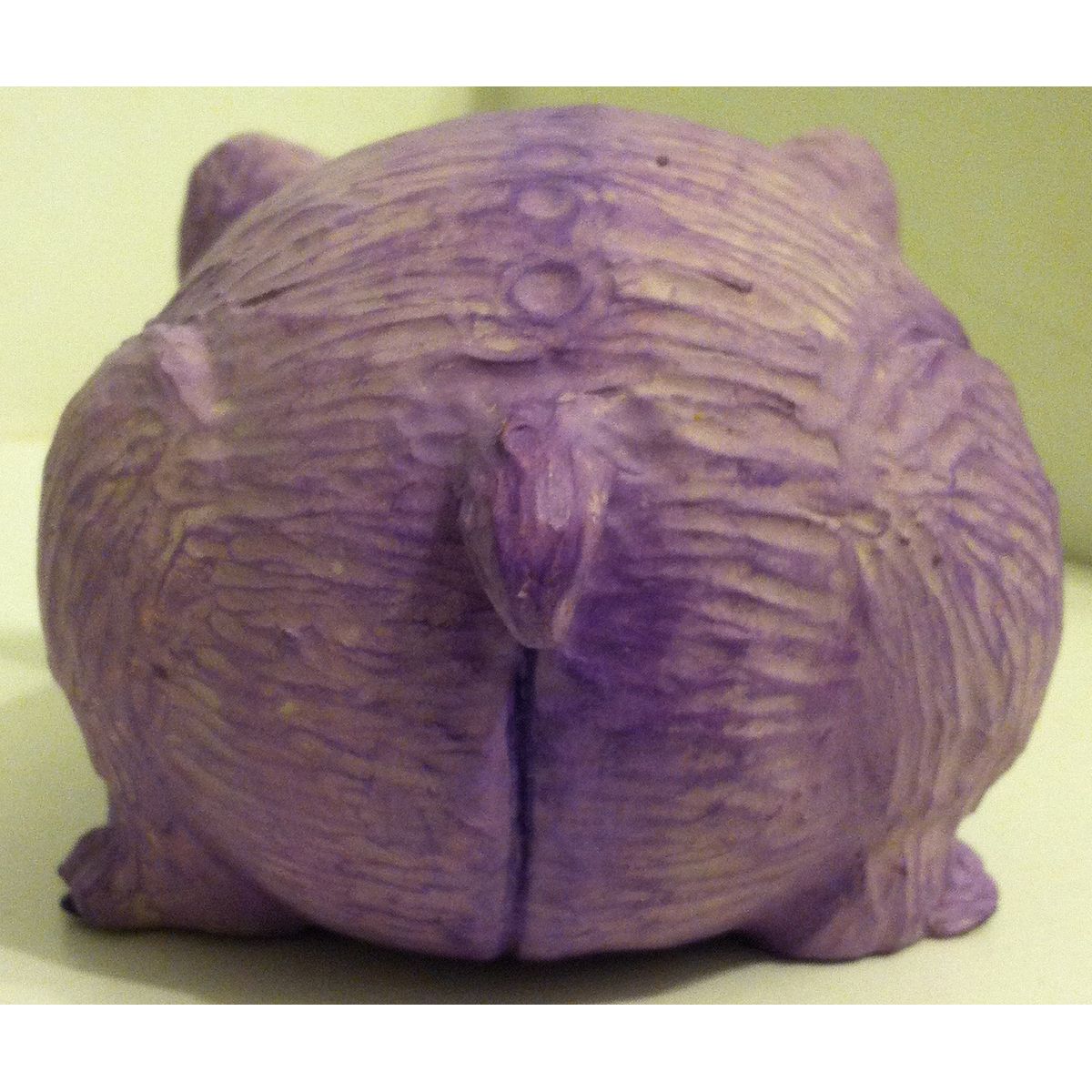 Creepy purple fat cat creature
