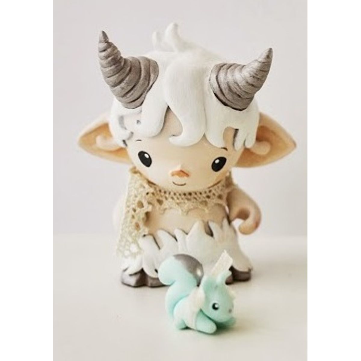 faun in white and tiny squirrel